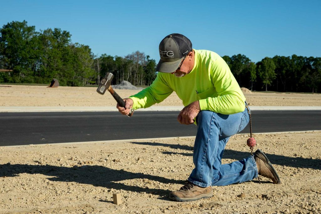 Construction stakeout crew member